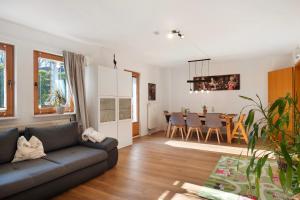 a living room with a couch and a dining room at Ruhige Schwarzwald Ferienwohnung in Buchenbach