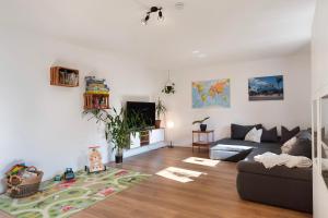 a living room with a couch and a tv at Ruhige Schwarzwald Ferienwohnung in Buchenbach