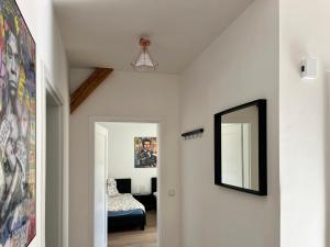 a hallway with a mirror and a bedroom at Frisch freche 3 R Ferienwohnung in Dohna