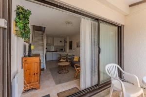 a view of a living room and kitchen from a balcony at La Forestière Cap Ferret - Réf 2 in Lège-Cap-Ferret