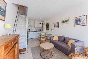 a living room with a couch and a table at La Forestière Cap Ferret - Réf 2 in Lège-Cap-Ferret +7 photos