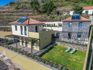 a house with solar panels on the roof at Ocean View Apartments in Caniço
