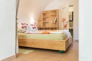a bedroom with a wooden bed in a room at Moserhof Ferienwohnung Sunnseit in Sarntal