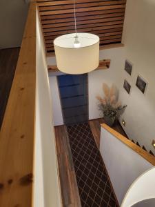 a staircase in a house with a pendant light at Hainberg-Loft mit Gartensauna in Mellrichstadt +33 photos