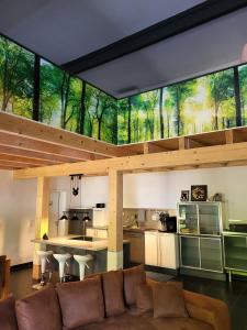 a living room with a couch and a large window at Hainberg-Loft mit Gartensauna in Mellrichstadt