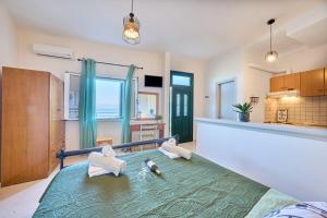 a kitchen with a bed with towels on it at Dolphin studio in Gaios