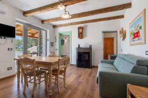 a living room with a table and a couch at Trulli House in Putignano