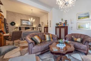 a living room with two couches and a bed at Pension Schlachter's Hius in Algermissen
