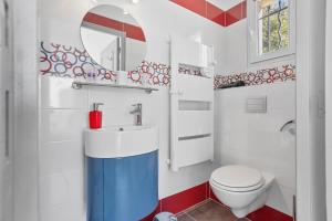 a bathroom with a toilet and a sink and a mirror at La Vue des Anges in Draguignan