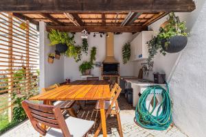 a patio with a wooden table and chairs at Casa do Rei - Charneca in Charneca