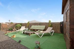 a patio with two chairs and a couch and a table at Casa Majos in Tesejerague