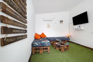 a room with a couch and tables and a tv at Casa Majos in Tesejerague