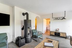 a living room with a fireplace and a tv at Haus Sonnenblick in Diemelsee