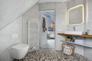 a bathroom with a toilet and a sink at Ferienhaus Karinella in Scharbeutz