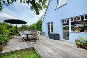 a patio with a table and chairs and an umbrella at Ferienhaus Karinella in Scharbeutz