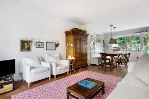 a living room with a couch and a table at Ferienhaus Karinella in Scharbeutz +24 photos
