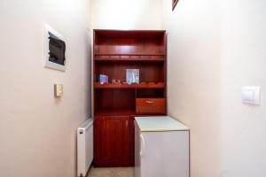 a kitchen with a refrigerator and a tv in a room at Captain Spiros Paxoi in Gaios