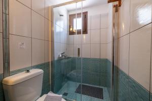 a bathroom with a toilet and a glass shower at Captain Spiros Paxoi in Gaios +36 photos