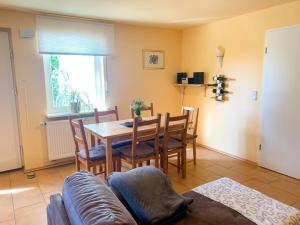 a living room with a table and chairs and a couch at Ferienwohnung Wadle in Gleisweiler