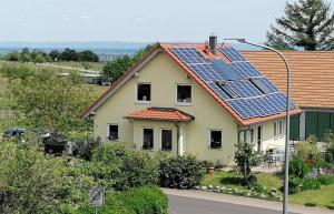a house with solar panels on the roof at Ferienwohnung Wadle in Gleisweiler