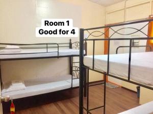 a room with two bunk beds with the words room good for at Amigos Homestay in Laguna