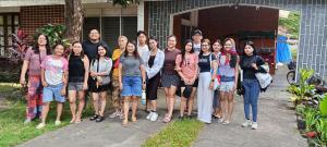 a group of people posing for a picture in front of a house at Amigos Homestay in Laguna