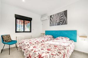 a bedroom with a bed and a chair at Ericito in Denia +23 photos