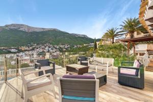 a balcony with chairs and a view of a city at Ericito in Denia