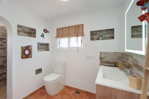 a white bathroom with a toilet and a sink at Espacio vivo Pisaverde in Tacoronte +27 photos