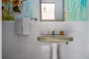 a bathroom with a sink and a mirror at Aquedarte in Lisbon +46 photos