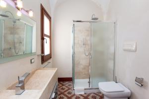 a bathroom with a shower and a toilet and a sink at Hora Vona in Orosei +20 photos