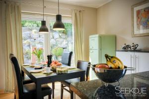 a kitchen with a table with a bowl of fruit on it at Seekoje - Haus Am Möhnesee in Möhnesee +14 photos