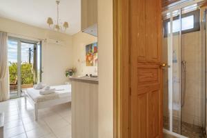 a bathroom with a shower and a sink and a tub at Nontas Home 23 in Kalamitsi +19 photos