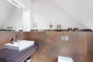 a bathroom with a sink and a mirror at Gut Vasbach Ferienwohnungen in Kirchhundem +41 photos