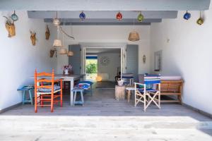 a dining room with colorful chairs and a table at Villa Baliba in Hyères