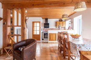 a kitchen with a table and chairs and a counter at Volets Verts in Aime-La Plagne