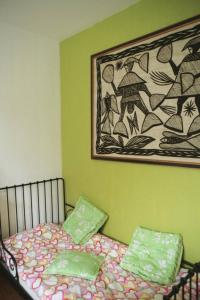 a bedroom with a bed with a picture on the wall at L'avocette in Sarzeau