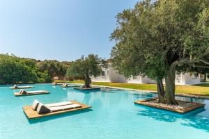a pool of blue water with boats in it at Ow Andros Suite 1,Private Whirlpool in Andros