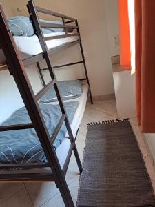 a room with two bunk beds and a rug at Hof Gerbert in Halenbeck