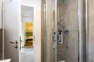 a bathroom with a shower with a glass door at Haus Sonnenblick in Diemelsee +52 photos