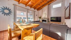 a living room with a couch and a table at Costacabana - Villa Nicky in Lloret de Mar