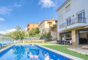 a villa with a swimming pool and a house at Costacabana - Villa Nicky in Lloret de Mar