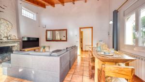 a living room with a couch and a fireplace at Costacabana - Villa Nicky in Lloret de Mar