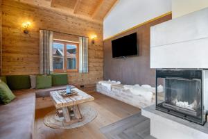 a living room with a fireplace and a tv at Bergchalet 2 in Freyung