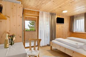 a bedroom with a bed and a desk and a window at Haus Vögel in Sibratsgfäll