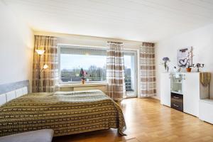 a bedroom with a bed and a window at Ferienappartement Möhnesee mit Pool in Möhnesee +21 photos