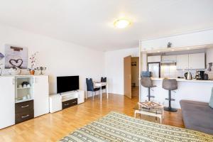 a living room with a couch and a table at Ferienappartement Möhnesee mit Pool in Möhnesee