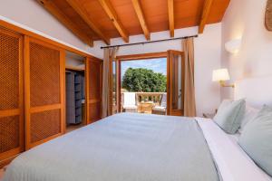 a bedroom with a white bed and a window at Can Petit Estel in Betlem +22 photos