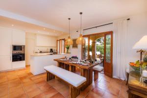 a kitchen with a wooden table and a dining room at Can Petit Estel in Betlem