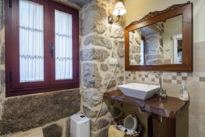 a bathroom with a sink and a mirror at C Vilamide in Parada de Achas +13 photos